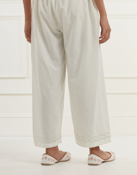 Off white chanderi cotton flax pants in a straight  fit with silver pittan embroidery at the hem