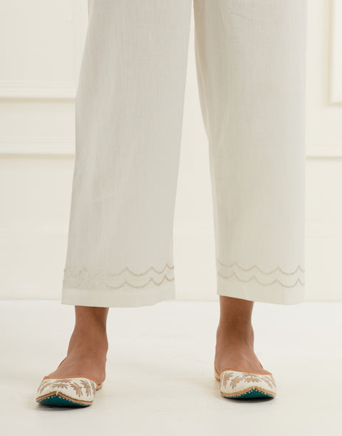 Off white chanderi cotton flax pants in a straight  fit with silver pittan embroidery at the hem